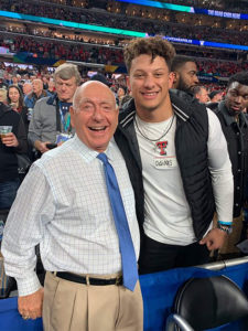 1UP Sports Marketing client Patrick Mahomes posing for a photo with American basketball sportscaster Dick Vitale
