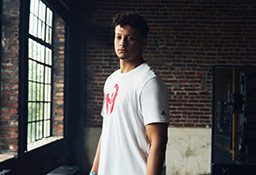 1UP Sports Marketing client Patrick Mahomes standing near a window