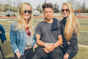 1UP Sports Marketing President Jacquelyn Dahl stands next to clients Patrick Mahomes and fiancé Brittany Lynne Matthews at the Maxim Big Game Experience event