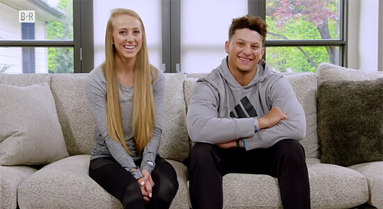 1UP Sports Marketing clients Patrick Mahomes and fiancé Brittany Lynne Matthews sit on a couch at their home