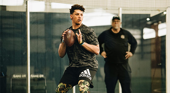 Patrick Mahomes preparing to throw a football in practice