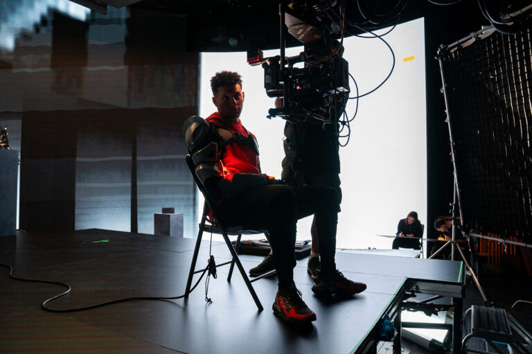 1UP client Patrick Mahomes sits in front of a high tech 3D modeling camera for his partnership with Fortnite.