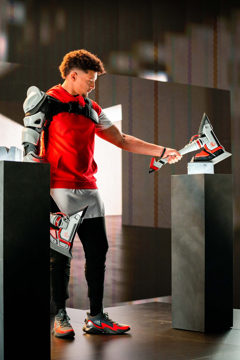 1UP client Patrick Mahomes holds a stylized axe weapon for his partnership with Fortnite.