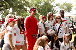 1UP Sports Marketing client Patrick Mahomes taking a group photos with kids where everyone is wearing Oakley sunglasses