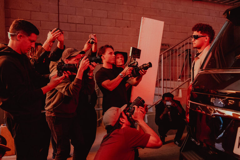 1UP Sports Marketing client Patrick Mahomes standing in front of a group of photographers wearing Oakley sunglasses