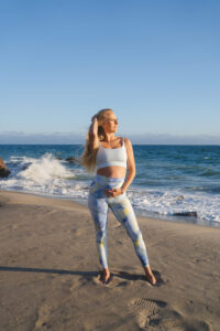 1UP Sports Marketing client Brittany Mahomes posing on the beach