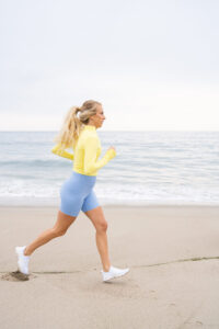 1UP Sports Marketing client Brittany Mahomes running on the beach